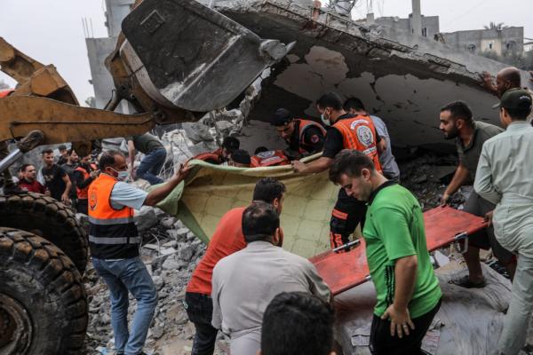 A civil defense team and civilians look for survivors under the rubble of a home destroyed in an Israeli airstrike on Rafah. October 23, 2023.