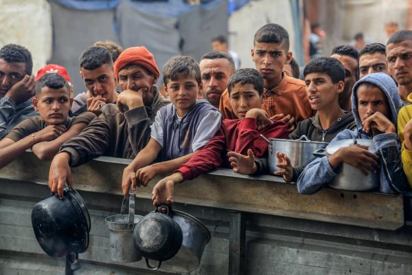 Palestinians await food assistance in Mawasi Khan Yunis due to Israel's policy of forced starvation during its genocide in Gaza.
