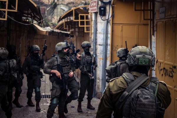 A group of Israeli soldiers patrol the streets of of the old city of Hebron.