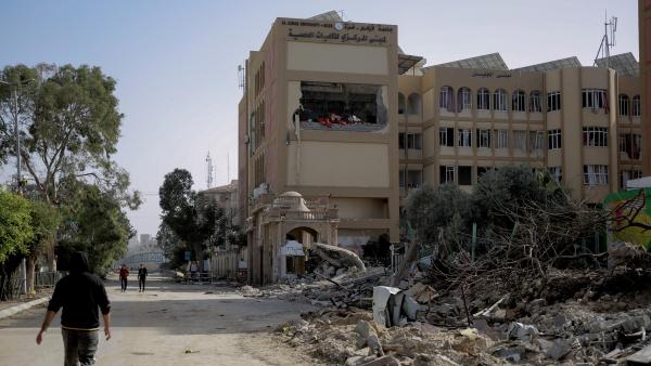 A Palestinian walks past a destroyed building of Al-Azhar University-Gaza's campus. November 26, 2023.