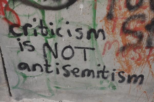 Graffiti on Israel's apartheid wall which says "criticism is NOT antisemitism."
