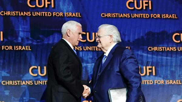 Vice President Mike Pence shakes hands on stage with Pastor John Hagee at a Christians United For Israel (CUFI) summit, 2019.