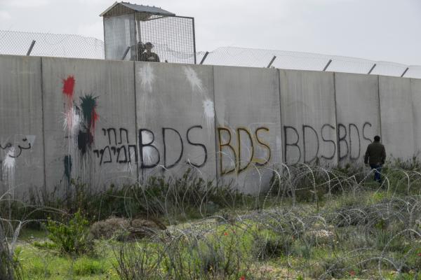 Grafitti on Israel's apartheid wall that says "BDS" several times in a row.