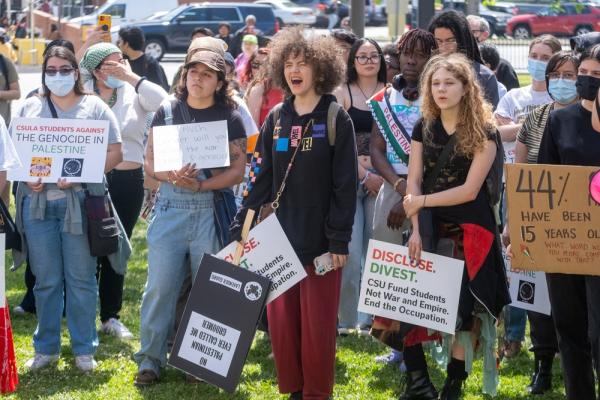 Students hold a rally at California State University, Los Angeles (CSULA) encampment, carrying signs demanding a ceasefire and that the university disclose and divest from Israel.