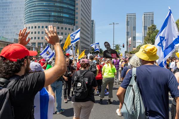 Protestors in Tel Aviv wave Israeli flags and carry posters with the faces of hostages to demand an end to the war on Gaza and their return.