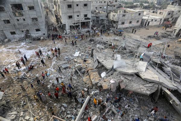 Palestinians in Rafah examine the damage to a home after an Israeli bombing. November 11, 2023.