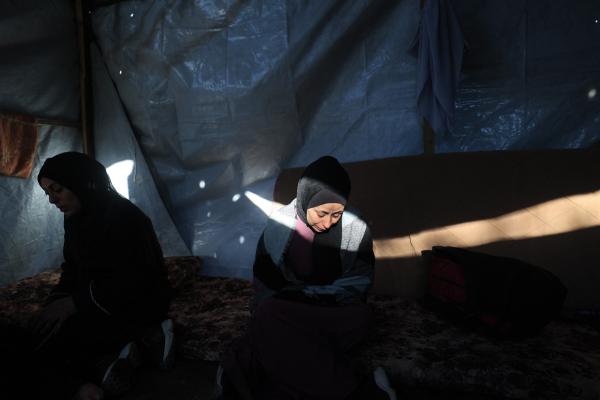Inside a tent in Gaza's Nuseirat refugee camp, Palestinian women mourn after an Israeli airstrike on March 9, 2026.