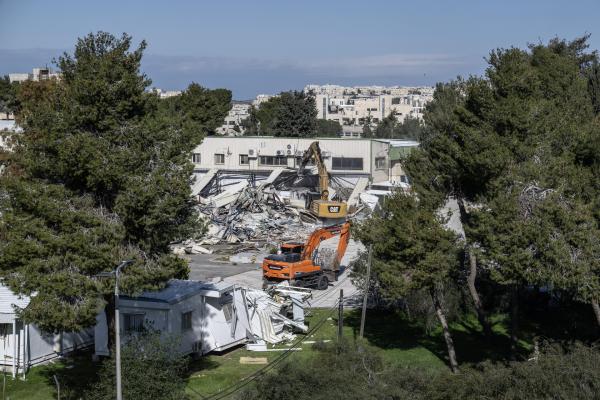 Israel demolishes UNRWA-compound buildings in the agency's headquarters in Sheikh Jarrah,  East Jerusalem. Israel Land Authority personnel use a Caterpillar and Develon demolition equipment. January 20, 2026.