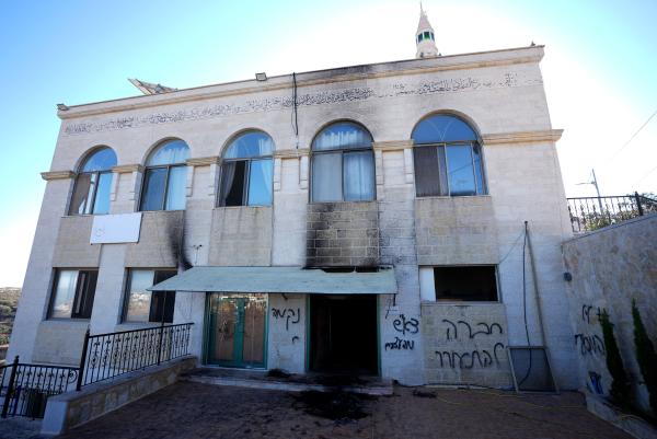 Damage to a mosque in the Jiljilya village near Ramallah after Israeli settlers set fire to the mosque and covered its facade with graffiti in Hebrew..