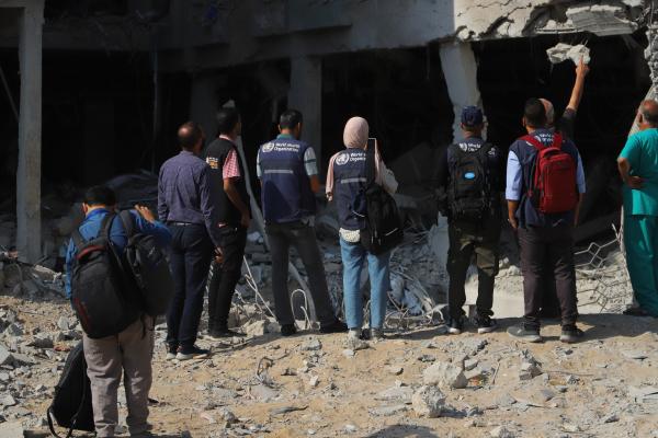 A WHO delegation inspects a heavily damaged building at Rantisi Children's Hospital in Gaza City.