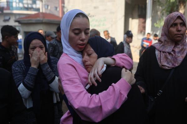 A Palestinian daughter hugs her mother as they mourn victims of an Israeli airstrike outside of the Shifa Hospital in Gaza City on November 20, 2025.
