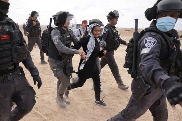 Israeli police arrest a young Palestinian Bedouin woman as she protests the JNF's afforestation project in Sawe al-Atrash, one of several areas of the Negev impacted by this JNF project.