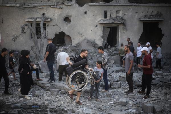Palestinians inspect the damage to buildings in Deir Al-Balah, central Gaza, after an Israeli airstrike on July 29, 2026.