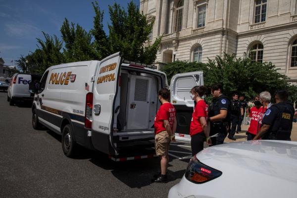 Capitol police arrest Jewish activists in a protest against Israel's genocidal war on Gaza. They wear t-shirts that read "NOT IN OUR NAME."