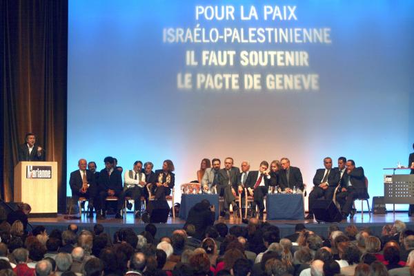 At an event in Paris celebrating the 2003 Geneva Initiative, French philosopher Bernard-Henry Levy speaks with the figures behind the Geneva Initiative with him on stage, including Yossi Beilin and Yasser Abed Rabbo. December 16, 2003.