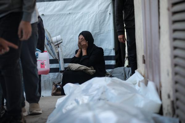 Palestinians in Deir al-Balah mourn  victims of an Israeli airstrike on November 23, 2025.