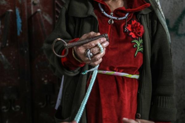 A Palestinian woman carries the key to the home she was forcibly expelled from in 1948. May 15, 2022.