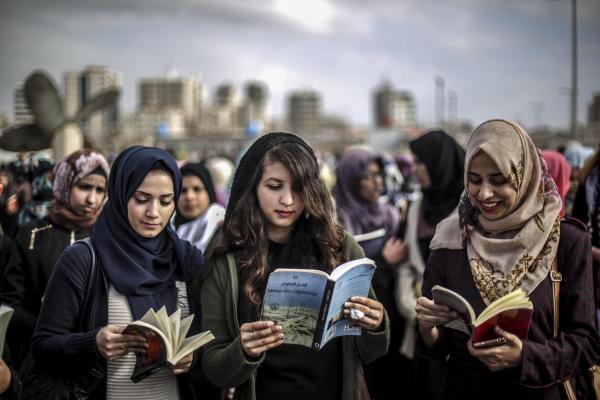 Palestinian women read books at a demonstration called "Gaza Reads" held at the Port of Gaza in protest of Israeli aggression against the West Bank and East Jerusalem. March 3, 2016. 